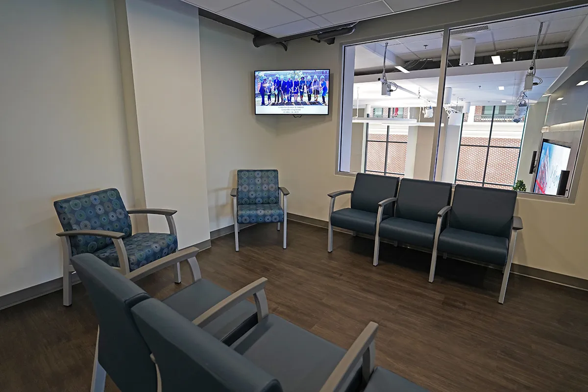 Digital signage displays in waiting room areas at Helping Up Mission
