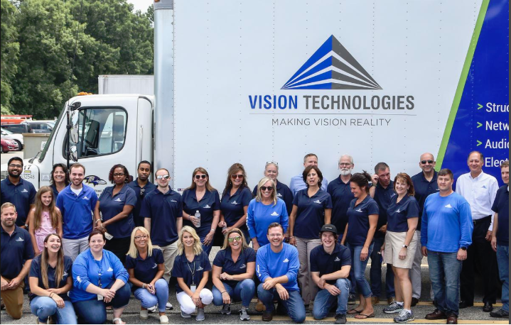 Vision employees in front of Vision Technologies truck