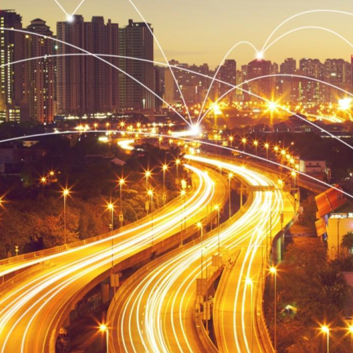 Highway leading into city with streaming lights